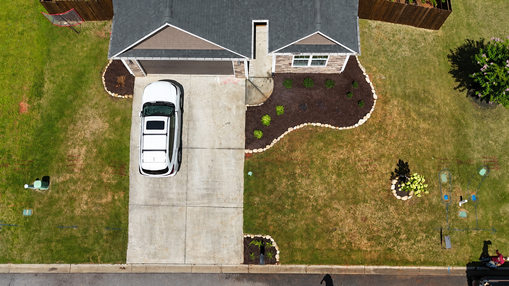Completed Bannister's Landscaping project with curved mulch beds and lawn